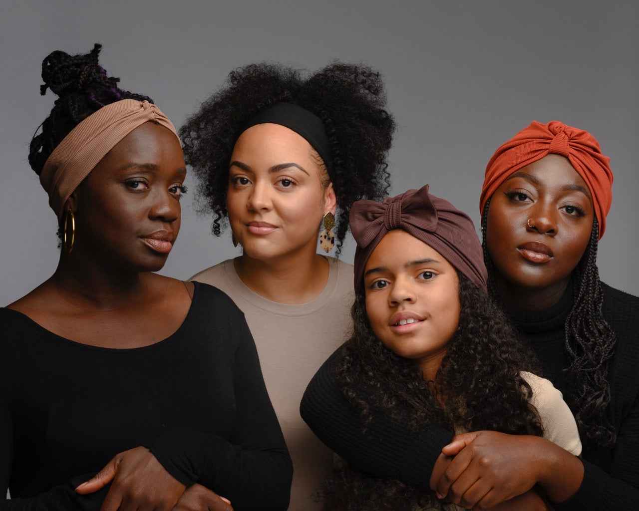 Four models wearing headbands and turbans