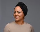 A woman model wearing a black turban