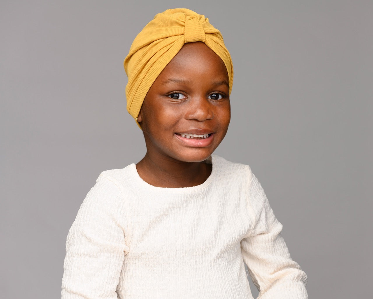 Child model wearing mustard turban