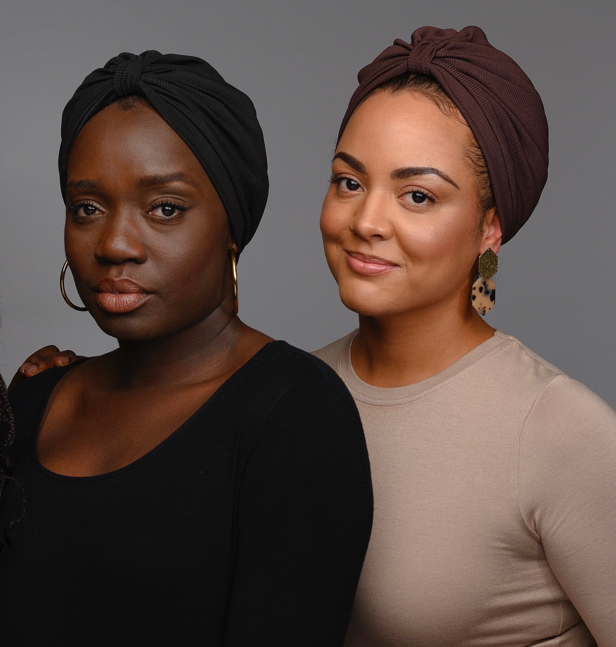 Black and chocolate turbans worn by two models